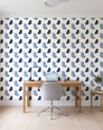 Dust & Wing Navy butterflies wallpaper behind a modern oak desk in a bright home office