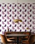 Dust & Wing Plum butterflies wallpaper behind a walnut credenza and round table in an elegant dining room
