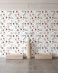 Ember & Leaf Garnet botanical floral wallpaper behind a travertine pedestal and vase in a minimal boutique