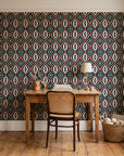 Ember & Iron Forest retro ogee wallpaper behind a vintage writing desk in a cozy craft-room home office