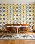 Ember & Iron Mustard retro ogee wallpaper in a mid-century dining room with a teak sideboard and tulip table