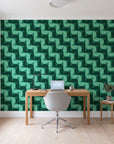 Ember Mosaic Emerald retro geometric wallpaper behind a modern oak desk in a bright home office