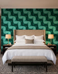 Ember Mosaic Emerald retro geometric wallpaper behind the headboard of a king bed in a contemporary hotel guest room