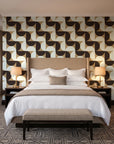 Ember Mosaic Mocha retro geometric wallpaper behind the headboard of a king bed in a contemporary hotel guest room