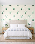 Falling Grace Emerald chevron wallpaper behind a queen bed in a bright coastal bedroom