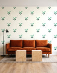 Falling Grace Emerald chevron wallpaper behind a rust velvet sofa in a bright coworking lounge