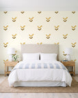 Falling Grace Ochre chevron wallpaper behind a queen bed in a bright coastal bedroom