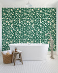 First Bloom Emerald ditsy floral wallpaper behind a freestanding tub in a bright coastal bathroom
