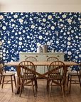 First Bloom Navy ditsy floral wallpaper in a farmhouse dining room with a sage sideboard and rustic trestle table