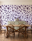 First Bloom Plum ditsy floral wallpaper in a farmhouse dining room with a sage sideboard and rustic trestle table