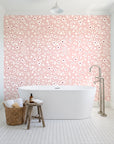 First Bloom Rose ditsy floral wallpaper behind a freestanding tub in a bright coastal bathroom