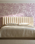 Forest Leaf Mulberry botanical leaf wallpaper behind a channel-tufted bed in a calm primary bedroom