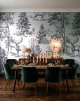 Frost & Fable Graphite woodland toile wallpaper in a dark moody dining room with a candlelit table