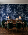 Frost & Fable Midnight woodland toile wallpaper in a dark moody dining room with a candlelit table