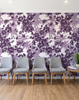 Frost Garden Veil Plum floral wallpaper behind a row of upholstered chairs in a bright clinic waiting room