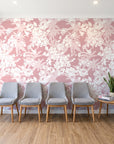 Frost Garden Veil Rose floral wallpaper behind a row of upholstered chairs in a bright clinic waiting room