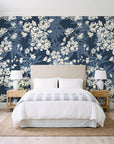 Frost Garden Veil Slate floral wallpaper behind a queen bed in a bright coastal bedroom