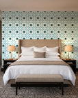Frost Mosaic Emerald geometric tile wallpaper behind the headboard of a king bed in a contemporary hotel guest room