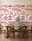 Garden Folly Rouge pastoral toile wallpaper in a farmhouse dining room with a sage sideboard and rustic trestle table