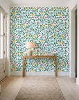 Garden Reverie Emerald floral wallpaper behind a console table in a light entry hallway
