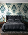 Gentlebotan Ivory botanical damask wallpaper behind a tufted headboard in a dark, moody bedroom