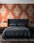 Gentlebotan Terracotta botanical damask wallpaper behind a tufted headboard in a dark, moody bedroom
