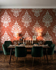Gentlebotan Terracotta botanical damask wallpaper in a dark moody dining room with a candlelit table
