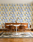 Gilded Crossing Navy chevron geometric wallpaper in a mid-century dining room with a teak sideboard and tulip table
