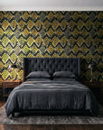 Gilded Crossing Onyx chevron geometric wallpaper behind a tufted headboard in a dark, moody bedroom
