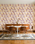 Gilded Crossing Oxblood chevron geometric wallpaper in a mid-century dining room with a teak sideboard and tulip table
