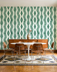 Gilded Rain Emerald geometric wallpaper in a mid-century dining room with a teak sideboard and tulip table