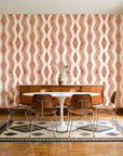 Gilded Rain Terracotta geometric wallpaper in a mid-century dining room with a teak sideboard and tulip table