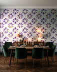 Gilt Scatter Plum floral scatter wallpaper in a dark moody dining room with a candlelit table
