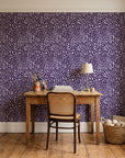 Grain Shift Aubergine minimalist dash wallpaper behind a vintage writing desk in a cozy craft-room home office