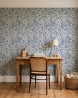 Grain Shift Oatmeal minimalist dash wallpaper behind a vintage writing desk in a cozy craft-room home office