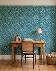 Grain Shift Teal minimalist dash wallpaper behind a vintage writing desk in a cozy craft-room home office