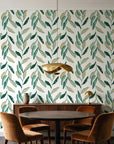Hanging Garden Emerald botanical wallpaper behind a walnut credenza and round table in an elegant dining room