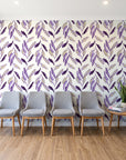 Hanging Garden Plum botanical wallpaper behind a row of upholstered chairs in a bright clinic waiting room