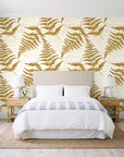 Harbor Fern Ochre fern wallpaper behind a queen bed in a bright coastal bedroom