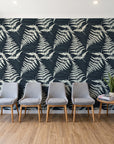 Harbor Fern Slate fern wallpaper behind a row of upholstered chairs in a bright clinic waiting room