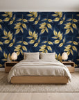 Harvest Crown Midnight leafy branch wallpaper behind a low platform bed in a serene Japandi bedroom