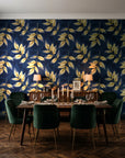 Harvest Crown Midnight leafy branch wallpaper in a dark moody dining room with a candlelit table