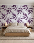 Harvest Crown Plum leafy branch wallpaper behind a low platform bed in a serene Japandi bedroom