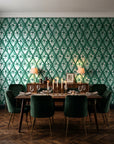 Hidden Court Emerald floral ogee wallpaper in a dark moody dining room with a candlelit table