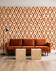 Hidden Court Terracotta floral ogee wallpaper behind a rust velvet sofa in a bright coworking lounge
