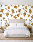 Hidden Garden Marigold floral wallpaper behind a queen bed in a bright coastal bedroom