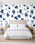Hidden Garden Navy floral wallpaper behind a queen bed in a bright coastal bedroom