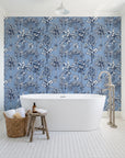 Hush & Palm Midnight palm trees wallpaper behind a freestanding tub in a bright coastal bathroom