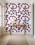 Ink & Oak Aubergine oak leaf and berry wallpaper behind a console table in a light entry hallway