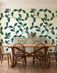 Ink & Oak Evergreen oak leaf and berry wallpaper in a farmhouse dining room with a sage sideboard and rustic trestle table